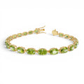 14K Gold Oval Shaped Peridot Tennis Bracelet 13.70 ctw by Orlina Fine